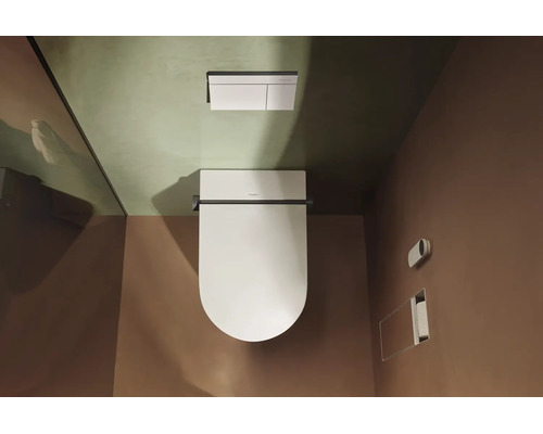 Vue de dessus d'un WC suspendu moderne avec abattant fermé et une plaque de déclenchement rectangulaire.