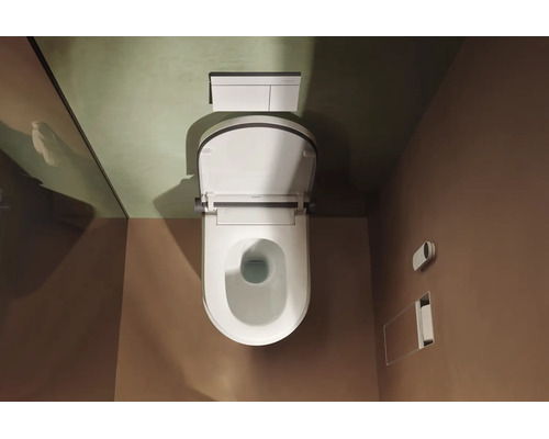 Vue de dessus d une toilette suspendue avec abattant ouvert, une plaque de déclenchement et un support accessoire encastré dans une salle de bain.