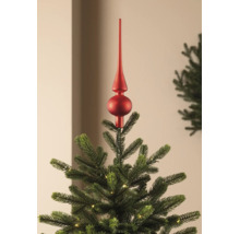 Cimier de sapin de Noël rouge mat sur un sapin vert avec un petit éclairage.