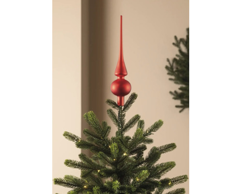 Cimier de sapin de Noël rouge mat sur un sapin vert avec un petit éclairage.