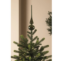 Dunkelgrüne Christbaumspitze aus glänzendem Glas auf einem künstlichen Weihnachtsbaum mit Beleuchtung.