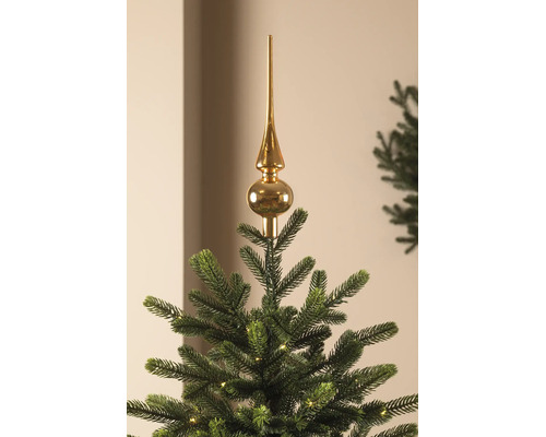 Cimier de sapin de Noël brillant sur un sapin de Noël avec des lumières.