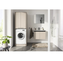 Salle de bains moderne avec meuble pour lave-linge, meuble sous-vasque suspendu avec lavabo et miroir au design lumineux.
