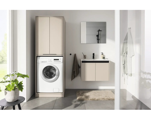 Salle de bains moderne avec meuble pour lave-linge, meuble sous-vasque suspendu avec lavabo et miroir au design lumineux.