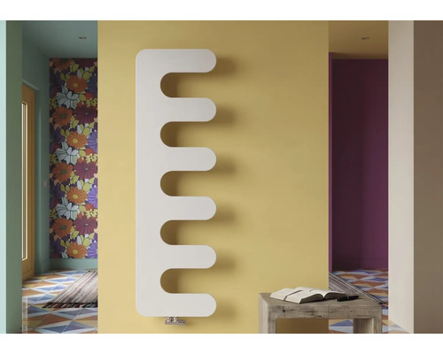 Radiateur design blanc moderne en forme de peigne sur un mur dans une pièce lumineuse et colorée.