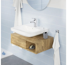Salle de bains moderne avec lavabo à poser sur un meuble sous-vasque suspendu en bois devant un mur carrelé.