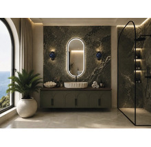Salle de bains moderne avec mur en marbre vert, miroir LED ovale, vasque à poser sur un meuble sous-vasque et douche à l'italienne.