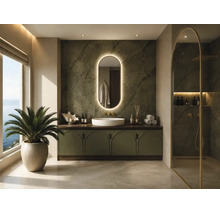 Salle de bains moderne avec meuble sous-vasque, vasque à poser, miroir ovale rétroéclairé, carrelage aspect pierre et paroi de douche en verre.