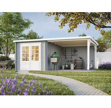 Abri de jardin en bois gris avec toit en appentis, double porte blanche et grand auvent de terrasse dans un jardin avec pelouse et allée pavée.