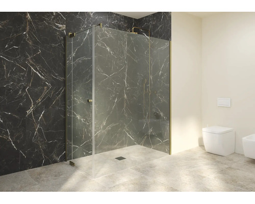 Cabine de douche moderne en verre avec ferrures et profilés dorés devant un mur sombre aspect marbre.