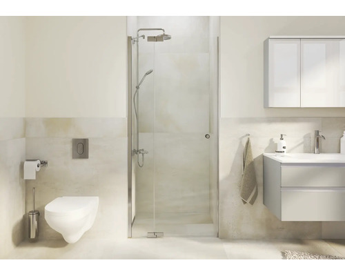 Salle de bain moderne avec cabine de douche en verre, toilettes suspendues et meuble vasque dans un design clair et organisé.
