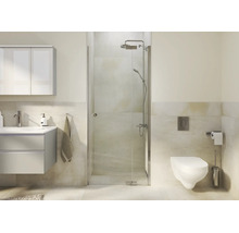 Salle de bain moderne avec cabine de douche en verre, lavabo et toilettes murales dans un environnement lumineux.
