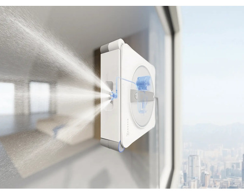 Robot laveur de vitres Ecovacs nettoyant une vitre avec fonction de pulvérisation