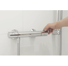 Hand bedient eine Grohe Thermostat Duscharmatur an einer gefliesten Wand