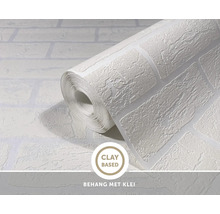 Tapetenrolle mit Ziegelsteinoptik und Textur aus tonbasierter Materialien.