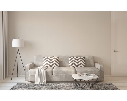 Salon lumineux avec canapé, coussins, tapis et lampadaire