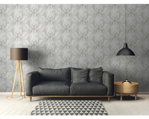 Wohnzimmer mit gemusterter Tapete, Sofa, Stehlampe und Beistelltisch