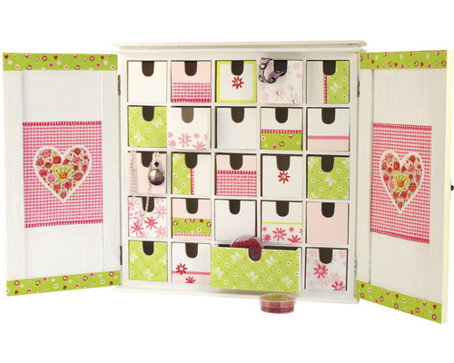 Offener weißer Adventskalender mit 24 Schubladen mit verschiedenen Mustern und Motiven.