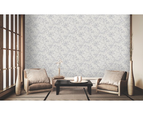 Wohnzimmer mit floral gemusterter Tapete, zwei Sesseln und Tatami-Matten.