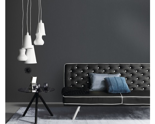 Wohnzimmer mit schwarzem Sofa, Beistelltisch und Pendelleuchten