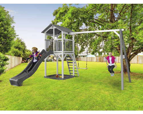 Toboggan pour enfants avec balançoire et tour de jeux dans le jardin