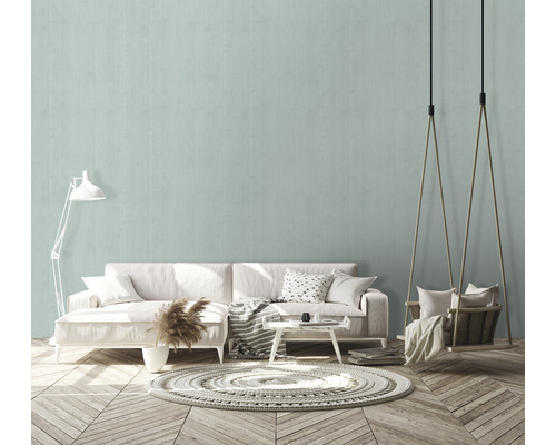 Wohnzimmer mit Sofa, Teppich und Schaukelstuhl