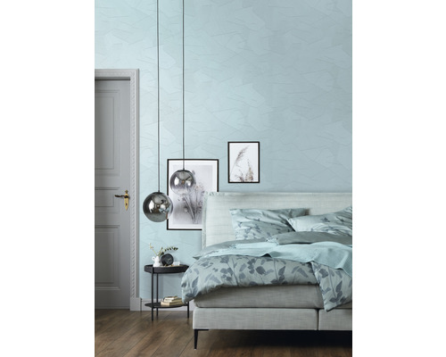 Chambre avec lit, table de chevet, suspensions et décoration murale