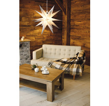 Wohnzimmer mit Sofa, Tisch und beleuchtetem Stern