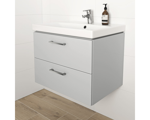 Meuble sous-lavabo avec deux tiroirs, robinetterie et distributeur de savon dans la salle de bain.