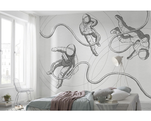 Schlafzimmer mit einer Fototapete mit Astronautenmotiv an der Wand