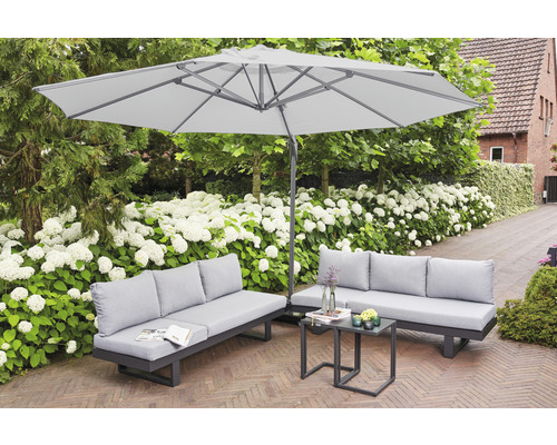 Gartenszene mit Sonnenschirm, Sofa und Tisch auf einer Terrasse