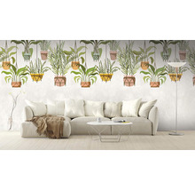 Salon avec canapé et papier peint photo avec motifs de plantes