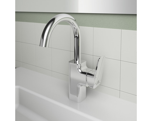 Chromfarbener Waschtischmischer vor weißem Fliesenspiegel