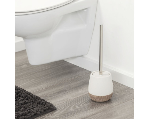 Brosse de toilette avec support à côté de toilettes