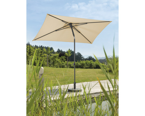 Parasol carré sur une terrasse en bois dans un jardin.