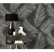 Ambiance de pièce avec papier peint à motif végétal, table et lampe