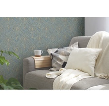 Salon avec un canapé gris, des coussins, une couverture, une table d''appoint avec une tasse et du papier peint à motifs