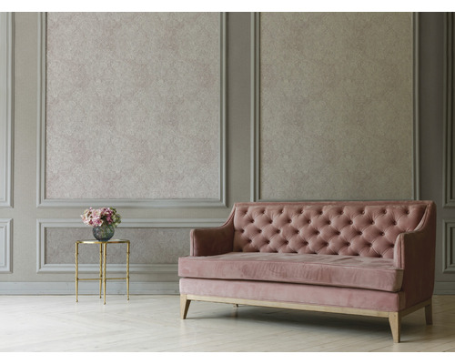 Wohnzimmer mit Wandpaneelen, gemusterter Tapete, Knopfpolster-Sofa und Beistelltisch mit Blumen