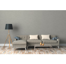 Wohnzimmer mit Ecksofa, Stehlampe und Couchtisch