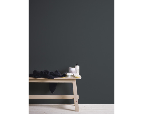 Étagère en bois clair avec serviette, pot de cosmétiques et distributeur de savon devant un mur sombre