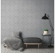 Wohnzimmer mit grauer geometrischer Tapete, Sitzhocker und Stehlampe