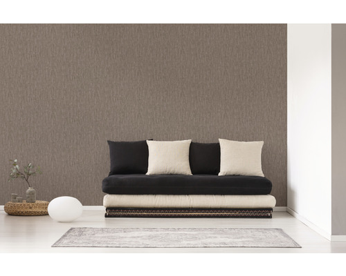 Une pièce avec un papier peint intissé marron, un futon et des décorations.