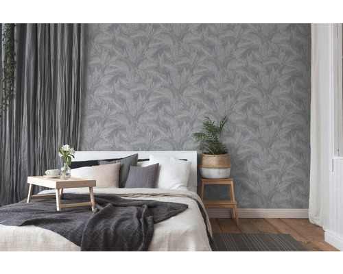 Schlafzimmer mit grauer Blättertapete, Bett und Vorhängen