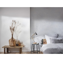 Helles Schlafzimmer mit Bett, Nachttischlampe und Dekoration
