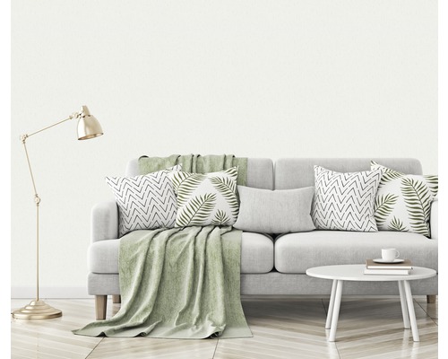 Scène de salon avec canapé, coussins, couverture, lampe et table d''appoint