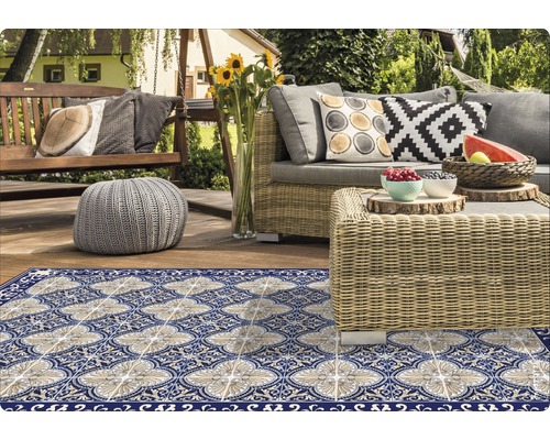 Terrasse mit Outdoor-Teppich, Korbmöbeln und Gartendekoration