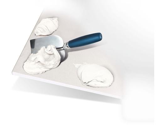 Spatule avec enduit sur une surface