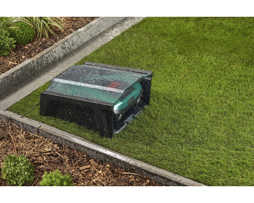 Robot tondeuse avec garage sur pelouse