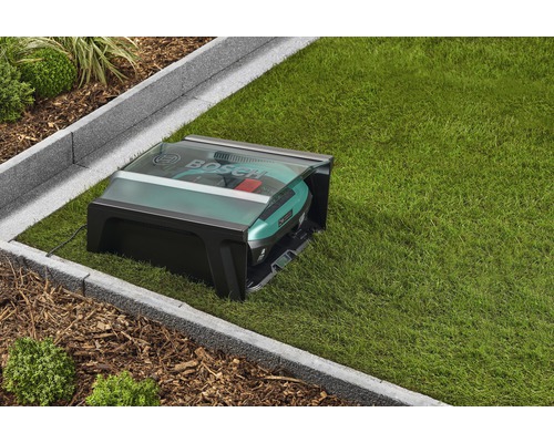 Logo Bosch. Robot tondeuse avec station de charge sur une pelouse.
