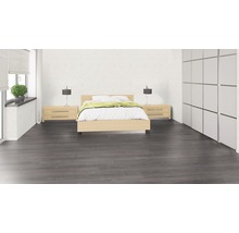 Schlafzimmer mit Bett, Nachttischen, Lampen, Schrank und grauem Holzboden